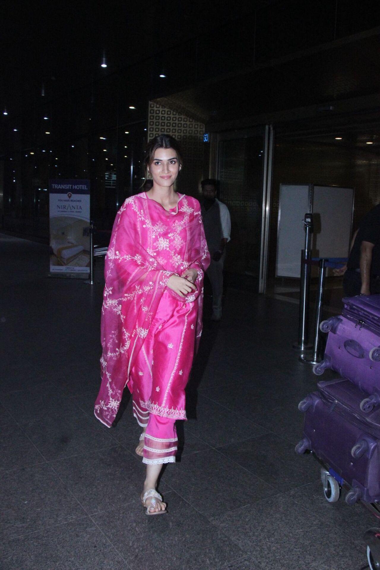 <p>While jetting off for one of the promotional tours, Kriti opted for a bright pink suit with white embroidery all over it.</p>